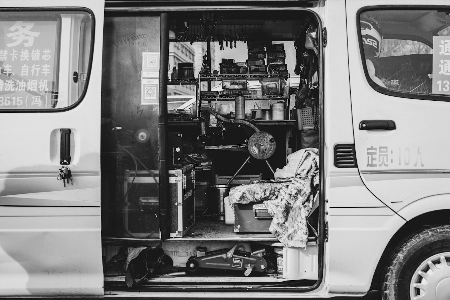 Open side door of a service van packed with tools.